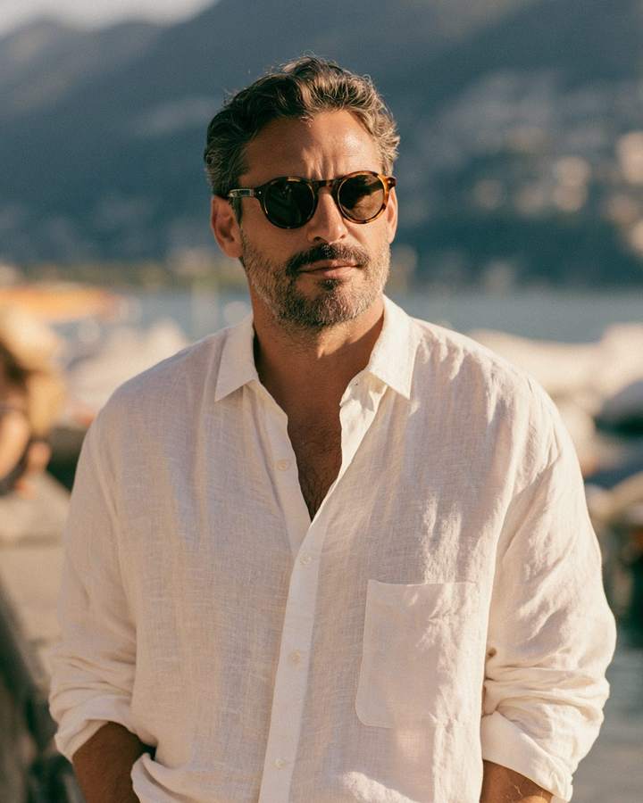 Mann mit Schildpatt-Sonnenbrille an einer Seepromenade